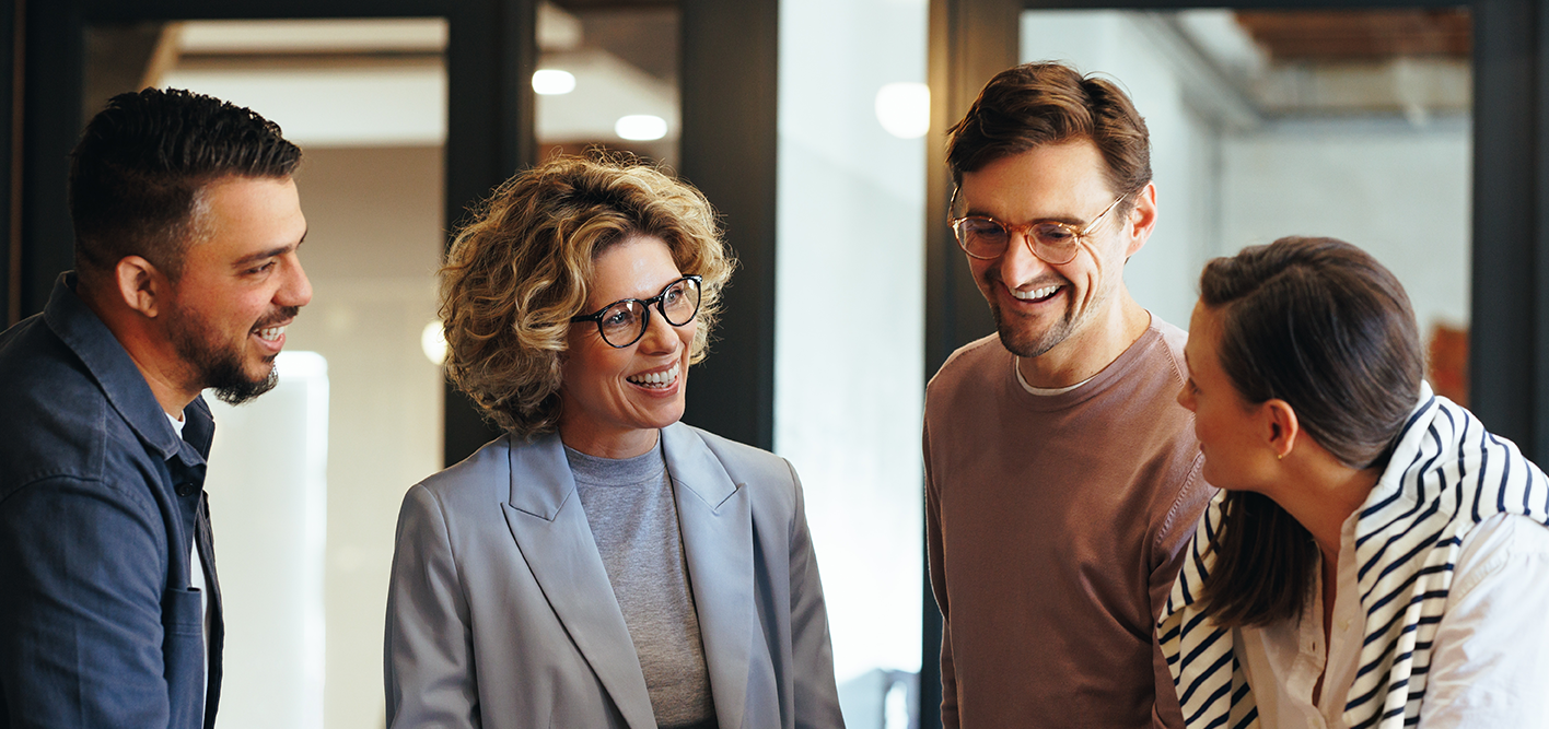 4 people having a conversation showing team spirit